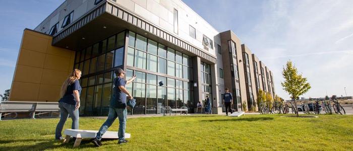 Students playing on Sunhawk Hall lawn